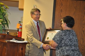 DSC_0270 Kathy Johnson, CEO/Administrator receives official plaque from Ken Peteron, MN Commissioner of the Department of Labor & Industry.
